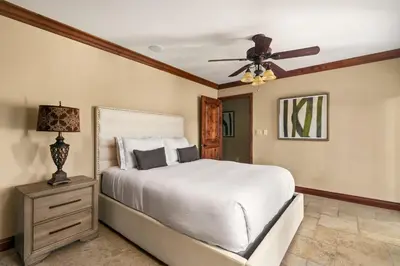 a bedroom with a bed and a ceiling fan at Grand Retreat Rooftop Bliss and Ocean Views in San Diego
