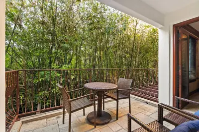 a patio with a table and chairs on a balcony at Grand Retreat Rooftop Bliss and Ocean Views in San Diego