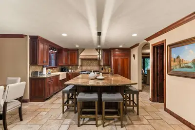 a kitchen with a large island with bar stools at Grand Retreat Rooftop Bliss and Ocean Views in San Diego
