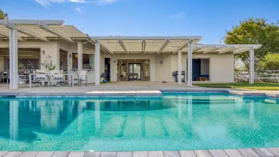 a swimming pool in front of a house at Summit Ranch by AvantStay Infinity Pool Views in Temecula