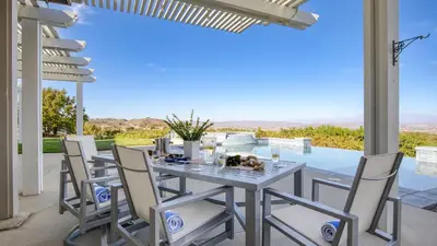 a table and chairs on a patio with a view at Summit Ranch by AvantStay Infinity Pool Views in Temecula