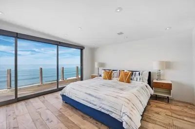 a bedroom with a large bed with a view of the ocean at Hi-Tech Hideaway - Modern & Ocean Front! in Solana Beach