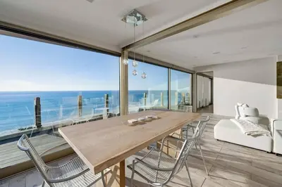 a dining room with a table and chairs and the ocean at Hi-Tech Hideaway - Modern & Ocean Front! in Solana Beach