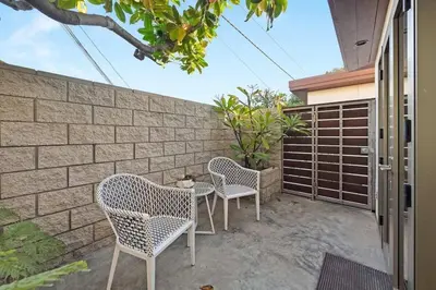 two chairs and a table on a patio at Hi-Tech Hideaway - Modern & Ocean Front! in Solana Beach