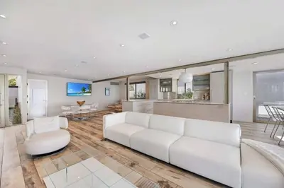 a living room with a white couch and a table at Hi-Tech Hideaway - Modern & Ocean Front! in Solana Beach