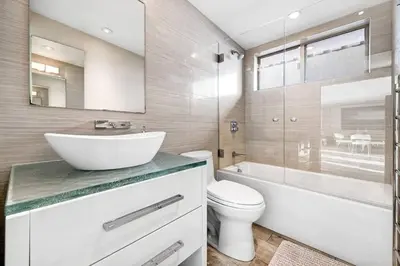 a bathroom with a sink and a toilet and a tub at Hi-Tech Hideaway - Modern & Ocean Front! in Solana Beach