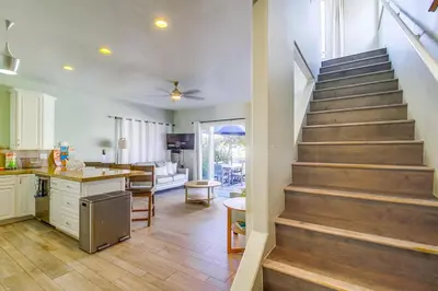 a kitchen and living room with a staircase in a house at Coastal Haven in San Diego