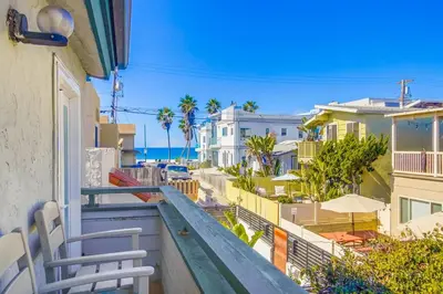 a balcony with a view of the beach and buildings at Coastal Haven in San Diego