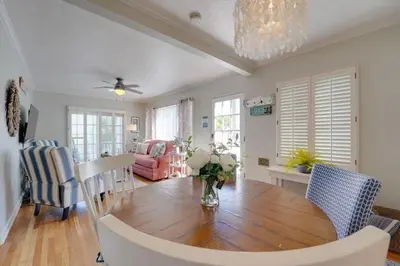 a dining room with a wooden table and chairs at Coral Cottage in San Diego
