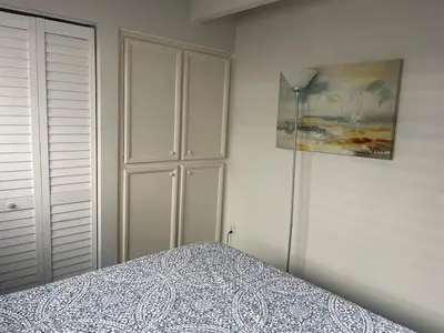 a bedroom with a bed and a white cabinet at South Mission Oceanview Beach Duplex in San Diego