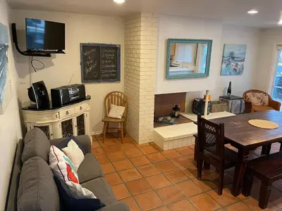 a living room with a couch and a table and a fireplace at South Mission Oceanview Beach Duplex in San Diego