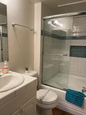 a bathroom with a shower and a toilet and a sink at South Mission Oceanview Beach Duplex in San Diego