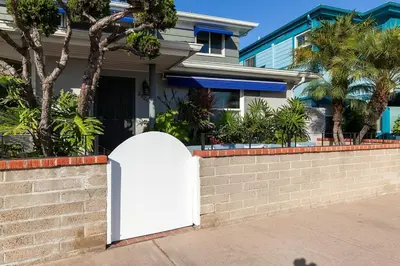 a white gate in front of a house at Bayfront 1-BR with Stunning View Steps to the Sand in San Diego
