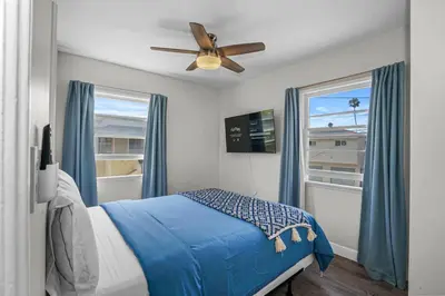 a bedroom with a bed and a ceiling fan at 500 ft to Ocean Relaxing stay Parking WiFi 838 in San Diego
