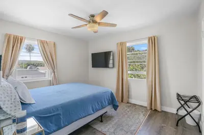 a bedroom with a blue bed and a ceiling fan at 500 ft to Ocean Relaxing stay Parking WiFi 838 in San Diego