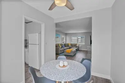 a kitchen and living room with a table and chairs at 500 ft to Ocean Relaxing stay Parking WiFi 838 in San Diego