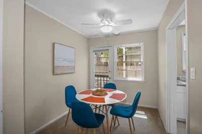 a dining room with a table and blue chairs at 500 ft to Ocean Relaxing stay Parking WiFi 840 in San Diego