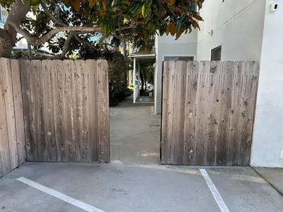 a wooden fence in front of a building at 500 ft to Ocean Relaxing stay Parking WiFi 840 in San Diego