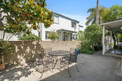 a patio with a table and chairs in front of a house at 500 ft to Ocean Relaxing stay Parking WiFi 840 in San Diego