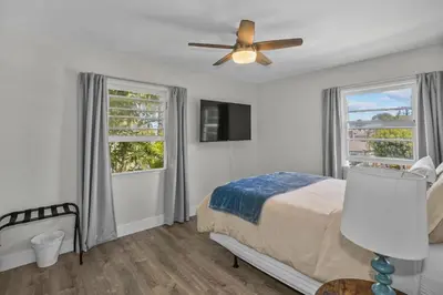 a bedroom with a bed and a ceiling fan at 500 ft to Ocean Relaxing stay Parking WiFi 836 in San Diego