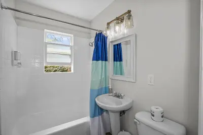 a white bathroom with a sink and a toilet at 500 ft to Ocean Relaxing stay Parking WiFi 836 in San Diego