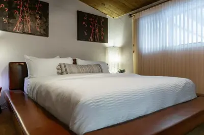 a large white bed in a bedroom with a window at Mountain Majesty with AC BBQ Parking in Lemon Grove