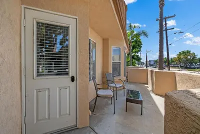 a door to a building with chairs and a table at Townhouse 1 Block From Bay With Yard & Parking in San Diego