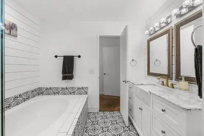 a white bathroom with a tub and two sinks at Townhouse 1 Block From Bay With Yard & Parking in San Diego