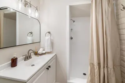 a white bathroom with a sink and a shower at 5BR Oasis with Pool, Arcade, Sauna in La Mesa