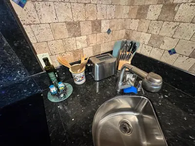 a kitchen counter with a sink and utensils at Guesthouse in Coastal Del Mar, California in San Diego