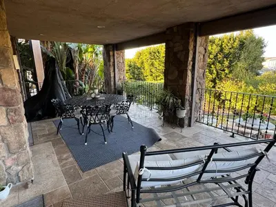 a patio with a table and chairs on a balcony at Guesthouse in Coastal Del Mar, California in San Diego
