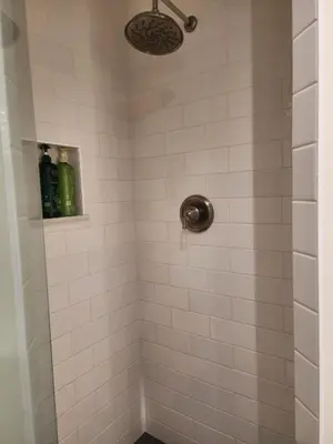 a bathroom with a shower with white tiles at Urban Beach Getaway 2 in San Diego