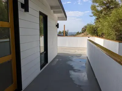 a porch of a house with a window and a fence at Newly Built, secluded, and tranquil Nest in Olivenhain in Encinitas