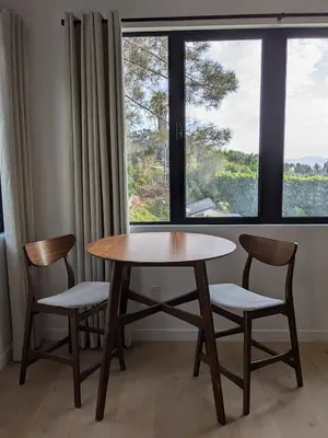 a table and two chairs in front of a window at Newly Built, secluded, and tranquil Nest in Olivenhain in Encinitas
