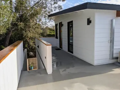 a small white building with a patio at Newly Built, secluded, and tranquil Nest in Olivenhain in Encinitas