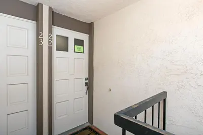 a hallway with a white door and a staircase at Breathtaking Bungalow - DMST22 in Solana Beach