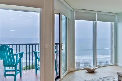 a room with a balcony with a view of the ocean at Breathtaking Bungalow - DMST22 in Solana Beach