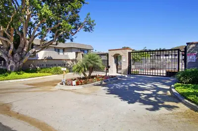 a driveway with a gate in front of a house at Second Wind - DMBC756S in Solana Beach