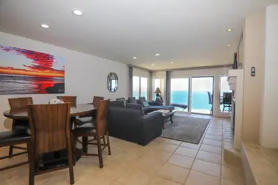 a living room with a couch and a table at Sunnyside Up! - SBTC213 in Solana Beach