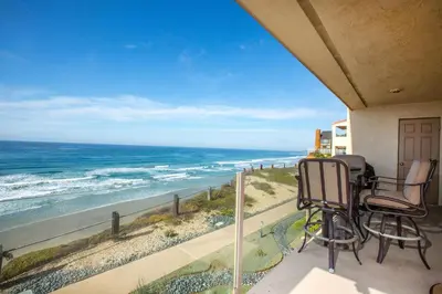 a balcony with two chairs and a view of the ocean at Sunnyside Up! - SBTC213 in Solana Beach
