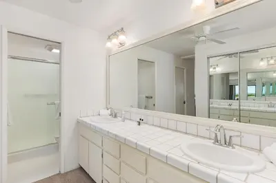 a bathroom with two sinks and a large mirror at Surf, Sun, Sand - SUR106 in Solana Beach