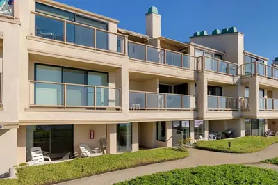 an apartment building with a balcony and lawn at Surf, Sun, Sand - SUR106 in Solana Beach
