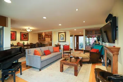 a living room with a couch and a piano at Adventure Awaits - SUR15 in Solana Beach