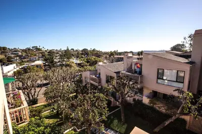 an overhead view of a house with trees and buildings at High Tides & Good Vibes SUR169 in Solana Beach