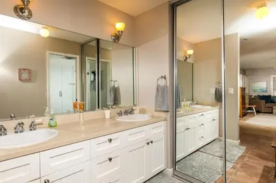 a bathroom with two sinks and two mirrors at High Tides & Good Vibes SUR169 in Solana Beach