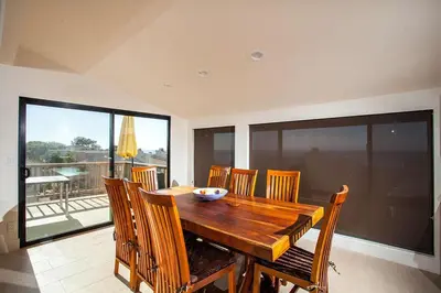 a dining room with a wooden table and chairs at Paradise Awaits - SUR182 in Solana Beach
