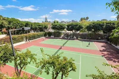 two tennis courts with people playing on them at Tranquil Living - SUR4 in Solana Beach