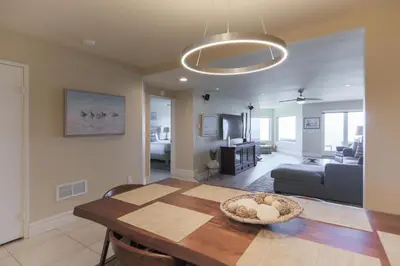 a living room with a table and a couch at Relax & Renew - SONG8 in Solana Beach