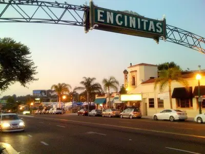 a street sign with cars parked on a city street at Coastal Soul - ENC656N in Encinitas
