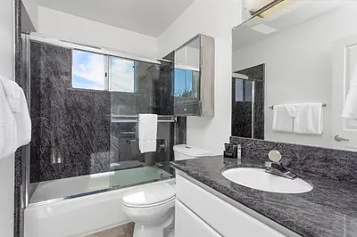 a bathroom with a sink and a toilet and a tub at Coastal Soul - ENC656N in Encinitas